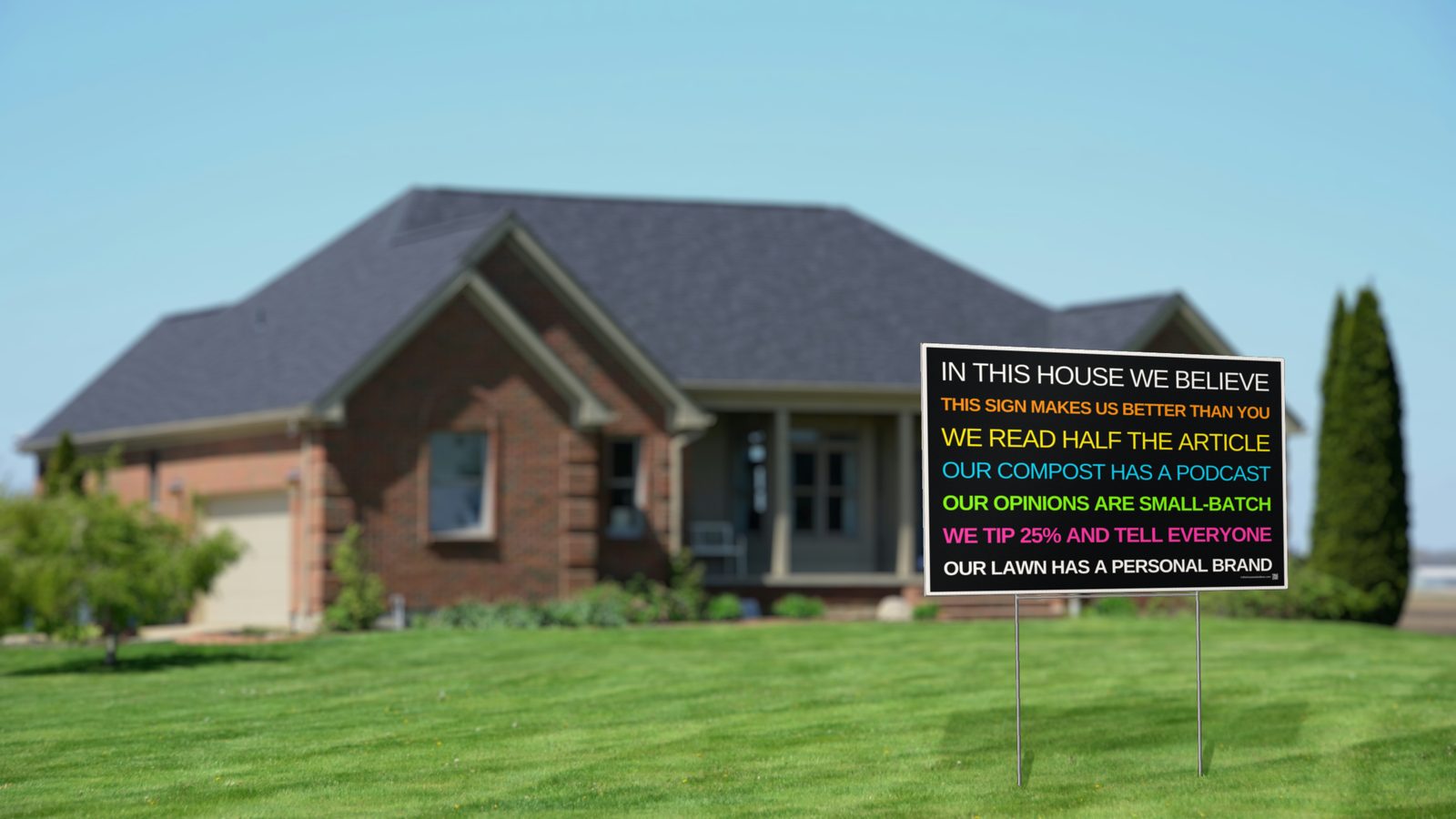 Satirical In This House We Believe yard sign in a front lawn reading "This sign makes us better than you"